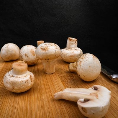 Organic Button Mushrooms with firm white caps and short stems, naturally providing B vitamins, selenium and potassium.