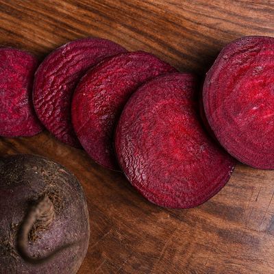 Organic beetroot (chukandar), fresh deep-red slices showing its earthy root and vibrant flesh.