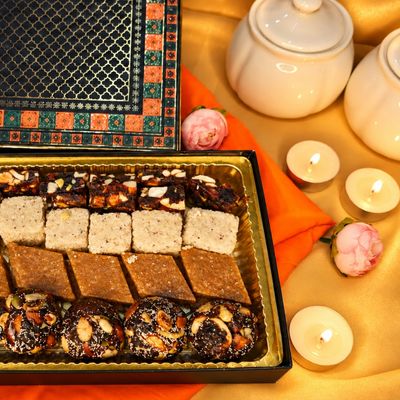 Festive Purple Medium Gift Box with assorted sweets, ornate lid and candles, elegantly arranged for Diwali gifting.