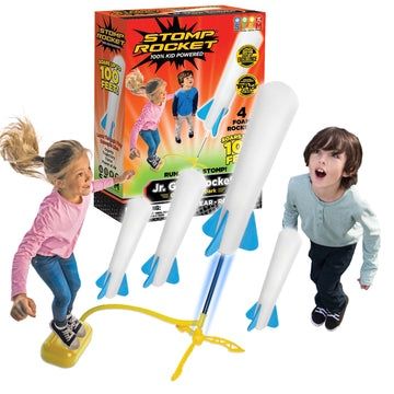 Child launching a glow-in-the-dark Stomp Rocket Jr. into the night sky.