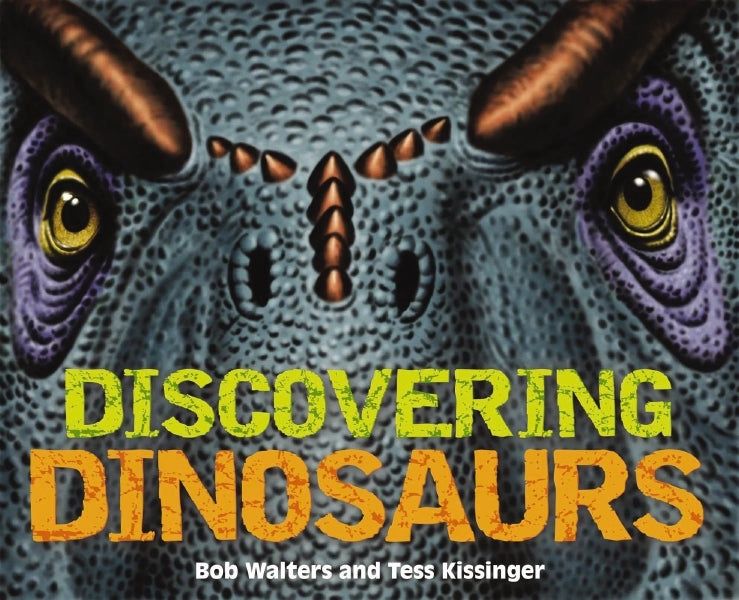 Cover of "Discovering Dinosaurs" featuring a close-up illustration of a dinosaur's face with textured skin and piercing eyes, set against a dark background.