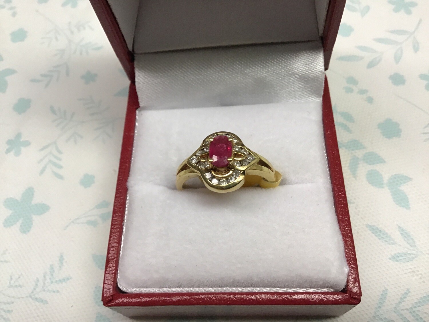 Genuine Oval cut Ruby with Diamond accents set in 14K Yellow gold