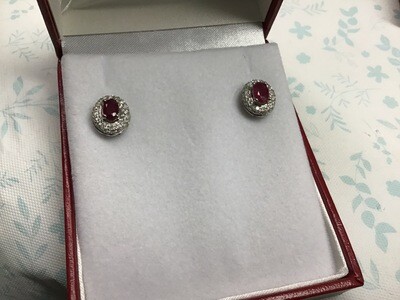 Ruby Earrings (Oval Shape) with a Diamond Halo set in 14 Kt. White Gold 56 pts. Total Weight