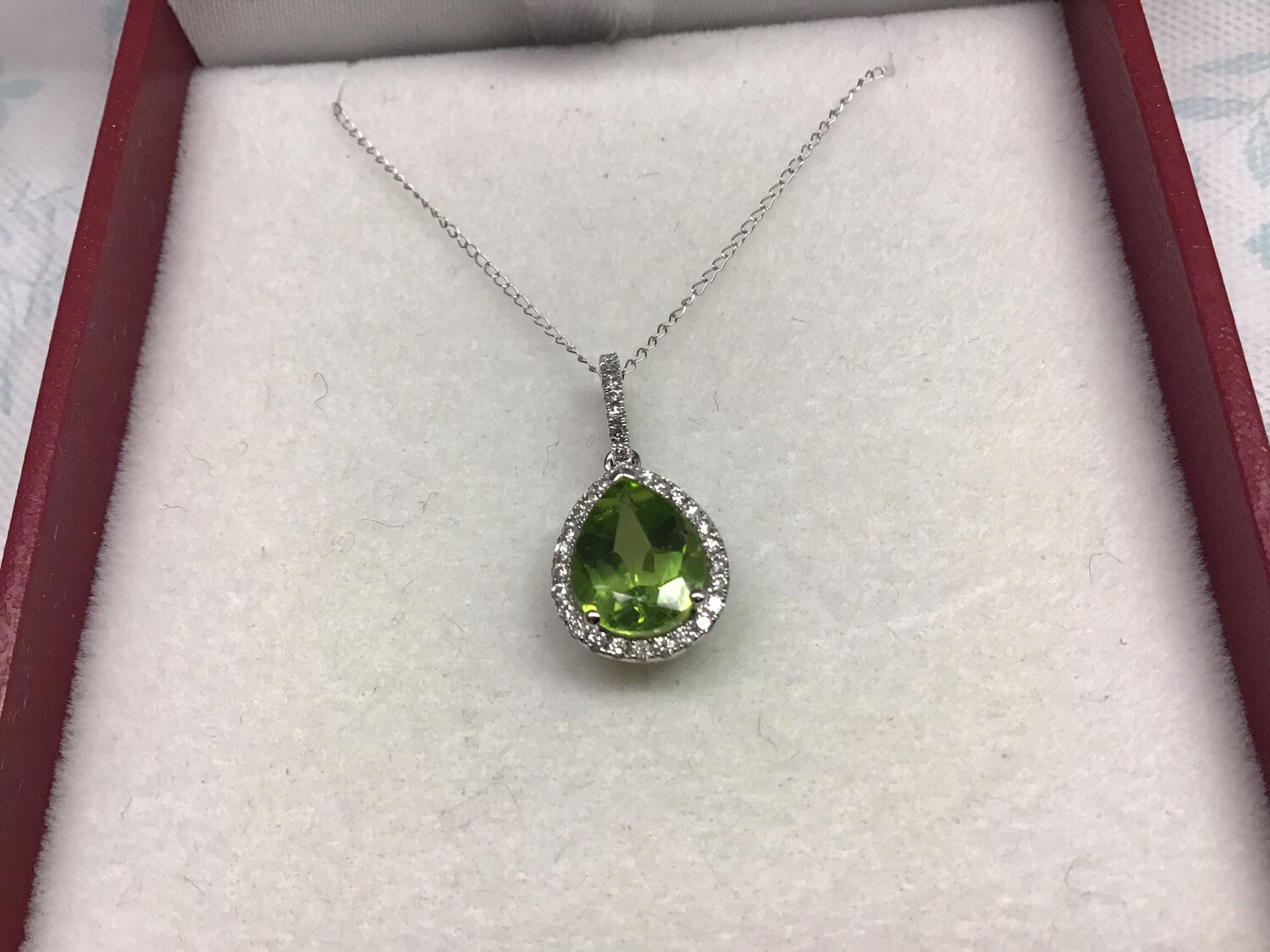 PERIDOT GREEN PEAR SHAPED NECKLACE CIRCLED WITH DIAMONDS SET IN A 14 KT.,