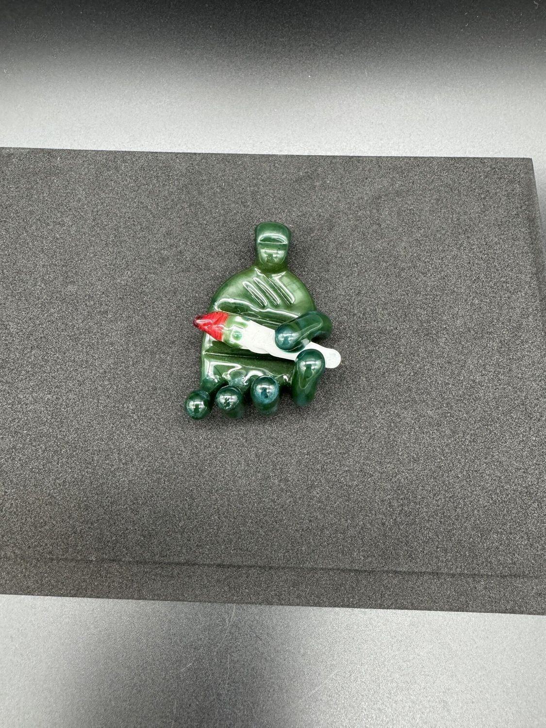 @glassvegas hand holding joint pendant