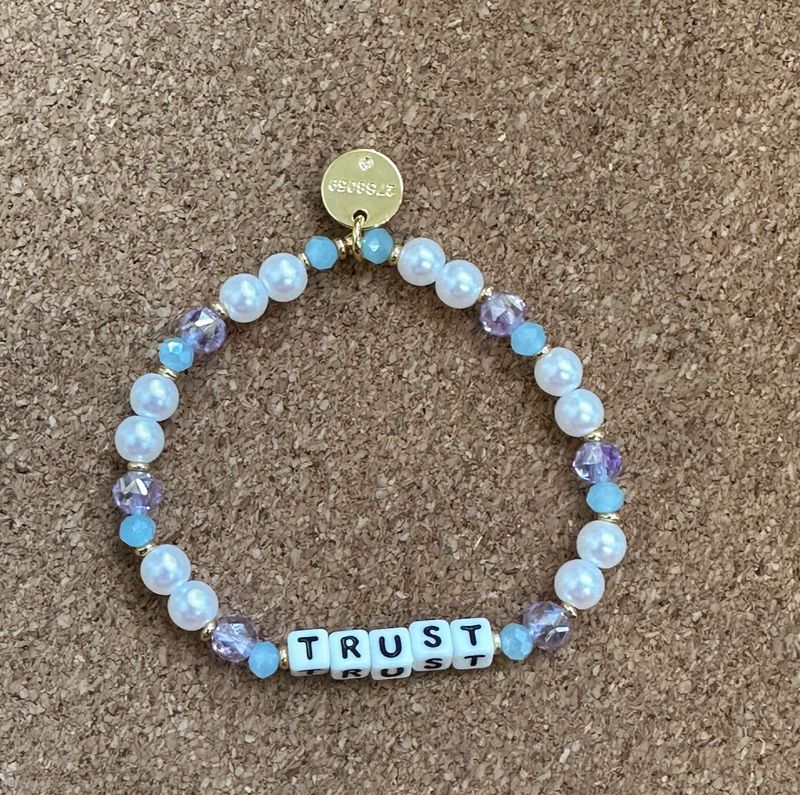 Little Words Trust Founder's Faith Bracelet with colorful beaded design and “Trust” word
