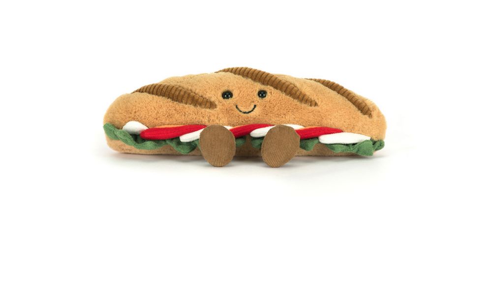 Jellycat Amuseables Caprese Baguette plush with smiling face, soft bread texture, and tomato and mozzarella filling detail