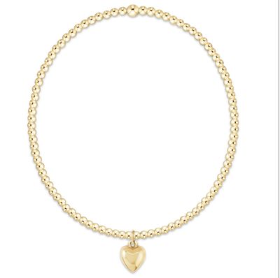  enewton 2mm gold beaded bracelet with plush small gold love charm, delicate stretch design perfect for stacking.