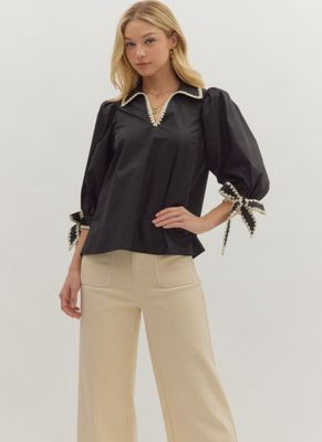 Solid 3/4 sleeve top featuring contrast scallop trim at collar