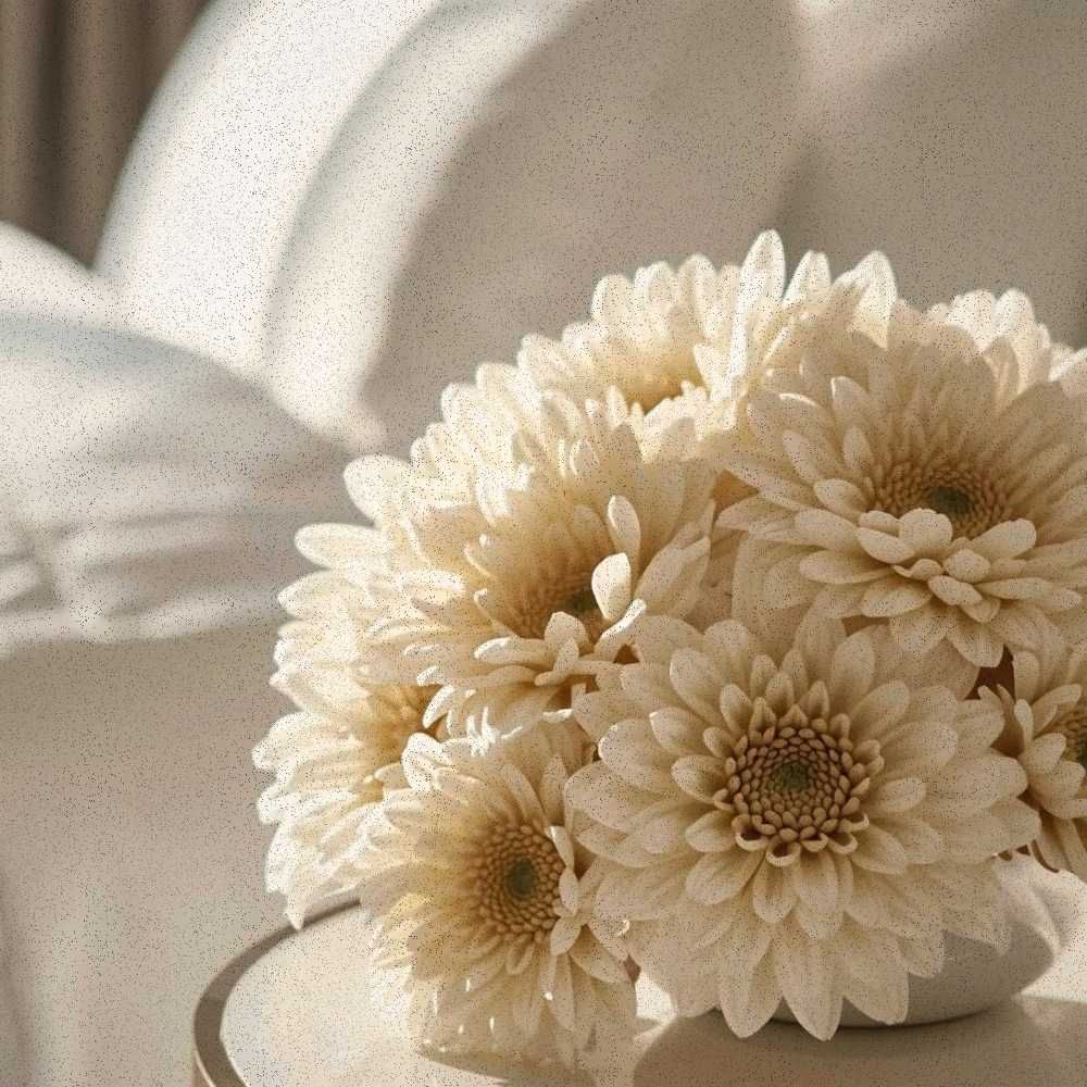 Minimalist hand-tied bouquet of sculptural white and butter yellow mums, editorial floral still life by CocoFleur.