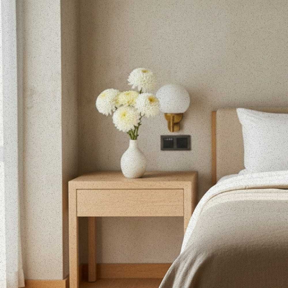 Sculptural white flower arrangement in a boutique hotel room setting, quiet luxury floral design for travel gifts