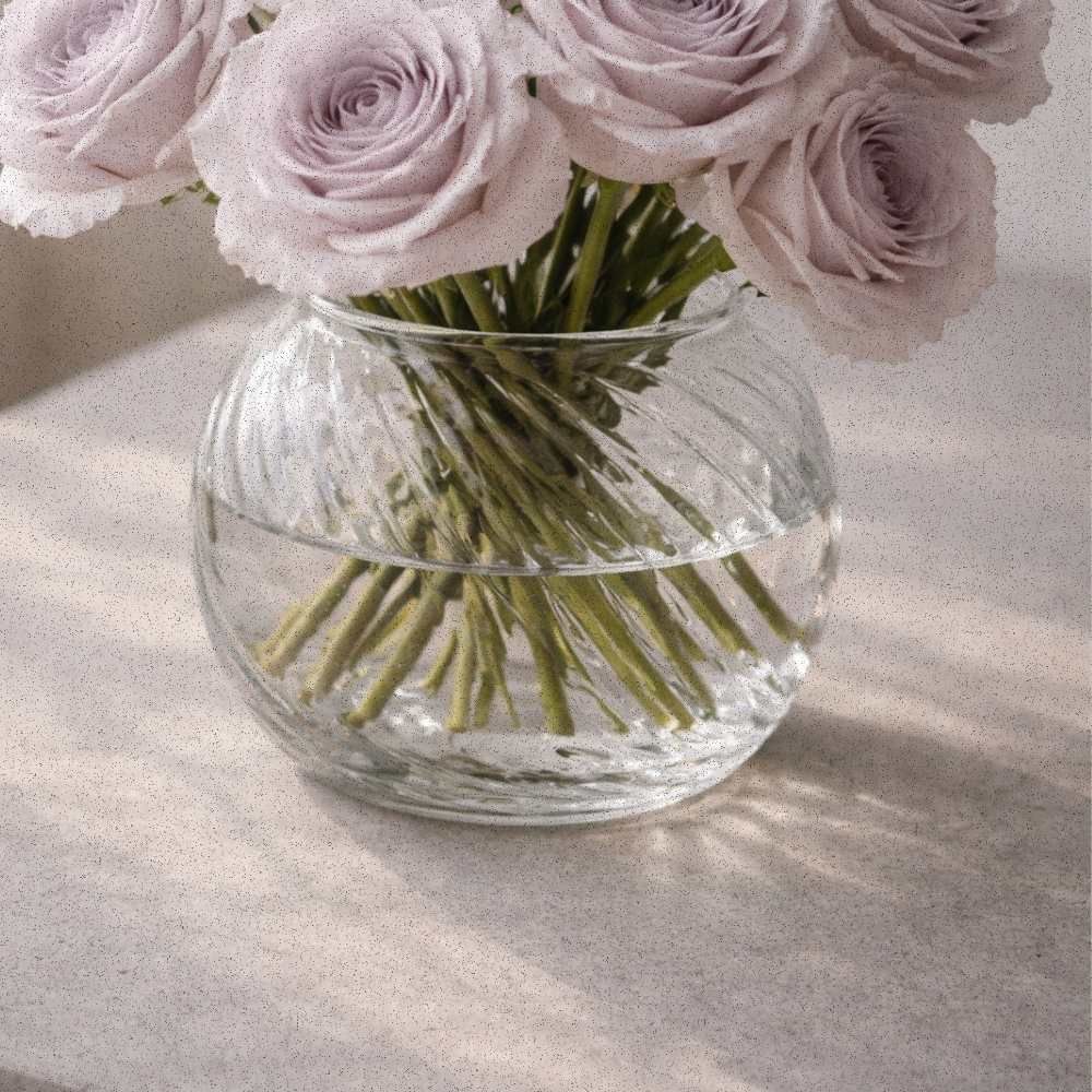 Stone-lilac roses arranged in a clear swirl glass vase, softly lit to reflect the calm of a winter morning.