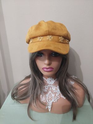 Gold newsboy hat.