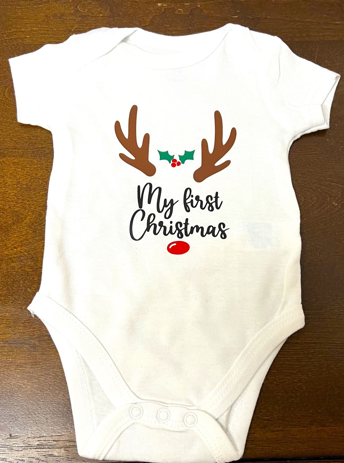 My first Christmas onesie with antlers and nose