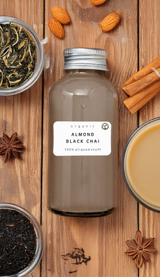 Bottle of Almond Black Chai smoothie with cinnamon sticks and tea leaves