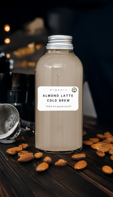 Bottle of Almond Latte Cold Brew with cold brew coffee beans and almonds