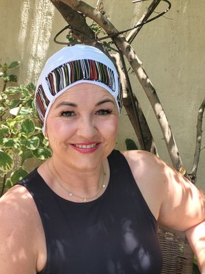 Carey white chemo hat with striped Ribbon