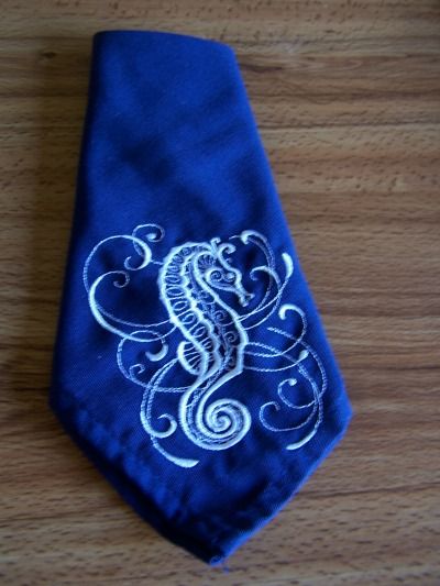 Two Damask style embroidered 18x18 inch Dark Blue Linen napkins with a white Seahorse design # 103 ****