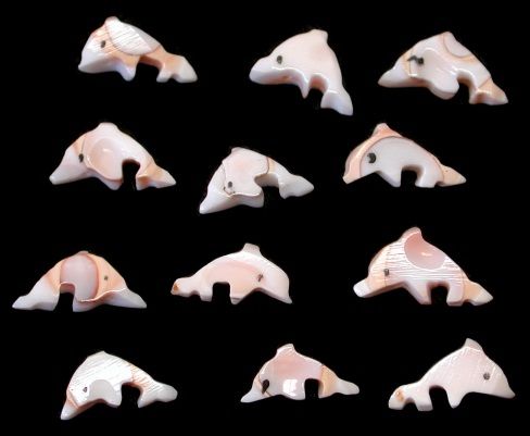 Dolphin Carved from Luhanus Shells measuring 1/2 to 3/4" with drilled hole Sold Each