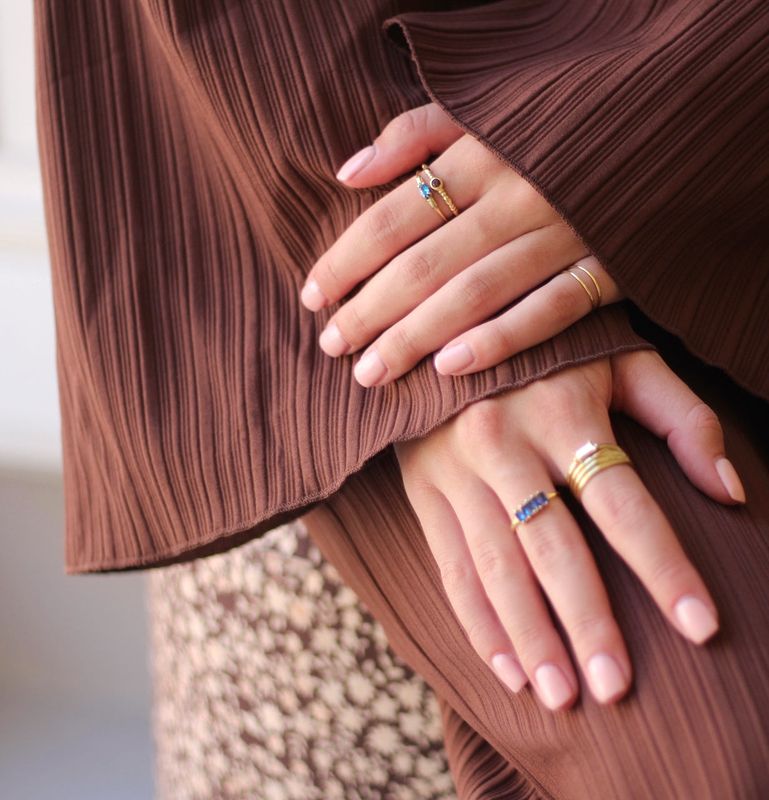 Xzota handmade brass ring with a subtle twisted design, worn as a regular ring on the hand."