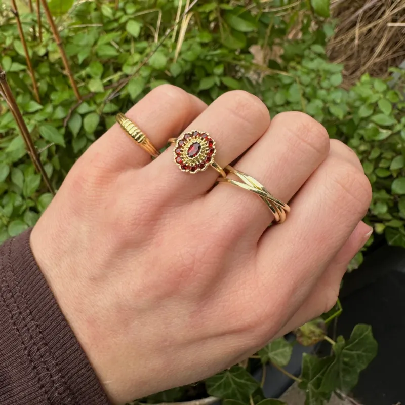Kae Garnet Ring worn on hand, showing its elegant fit and vintage style with a deep red garnet stone.