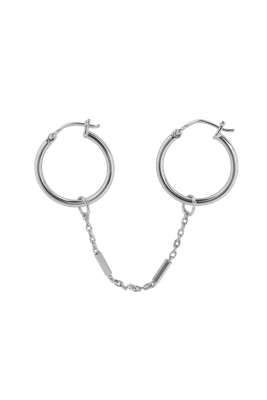 Handmade 925 sterling silver earring by Xzota, with a chain connecting two small hoops. Available at Maison Maeva.