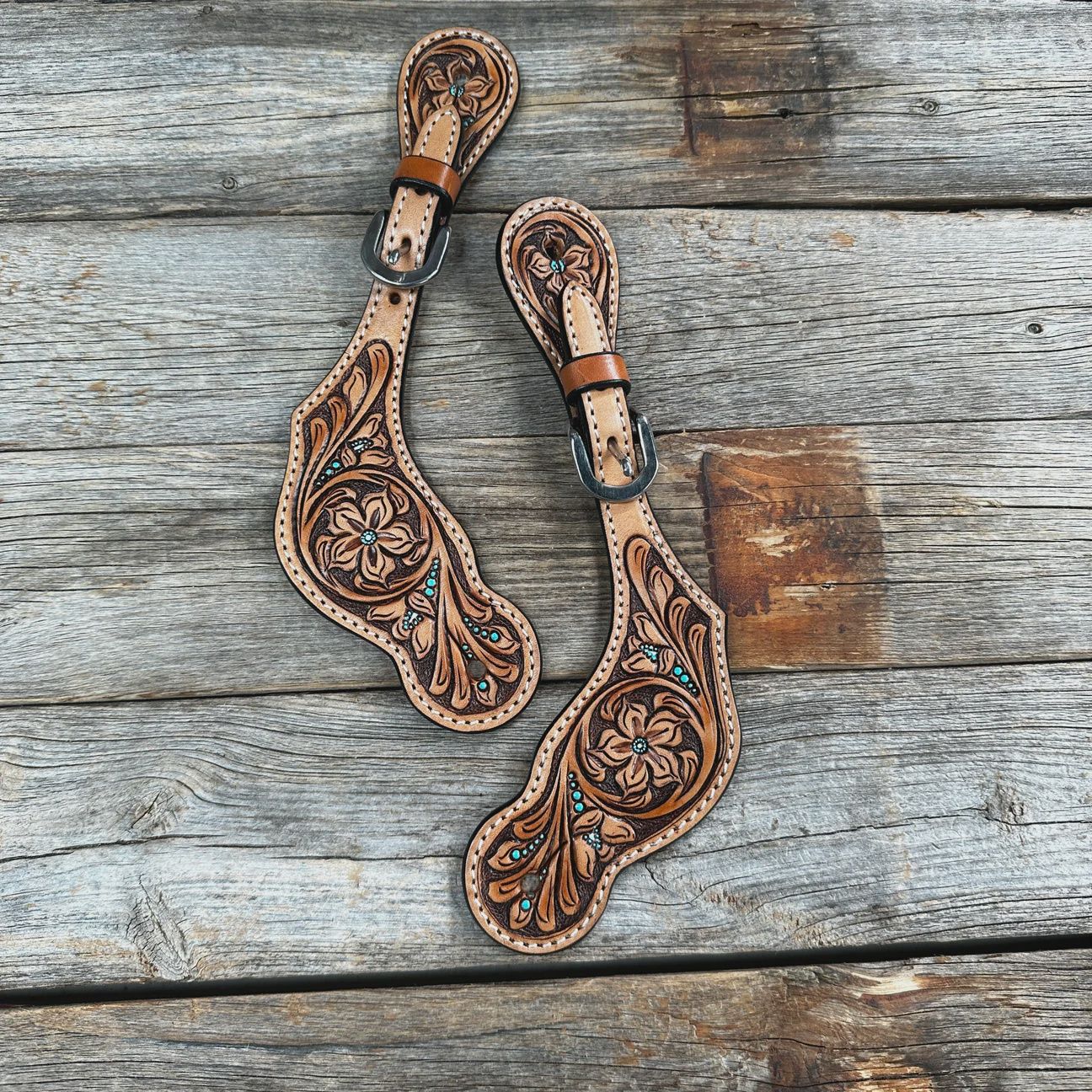 Floral and teal dot tooled spur straps