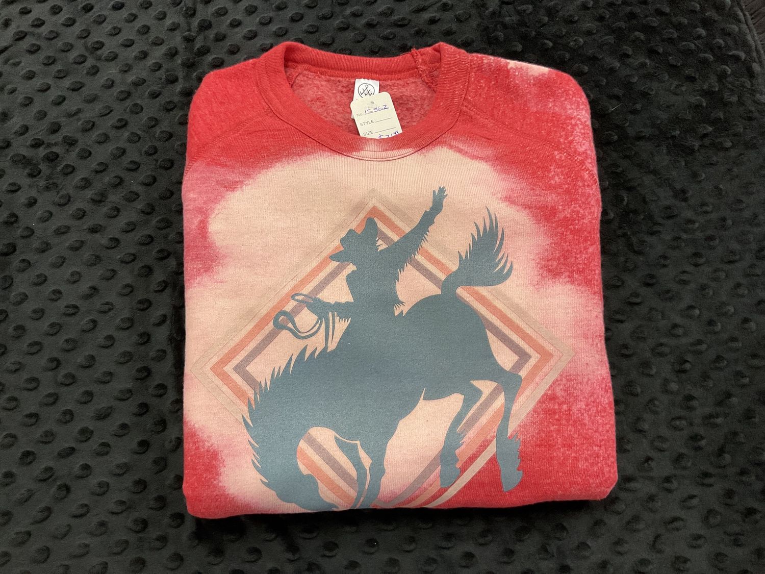 Red sweatshirt riding cowboy
