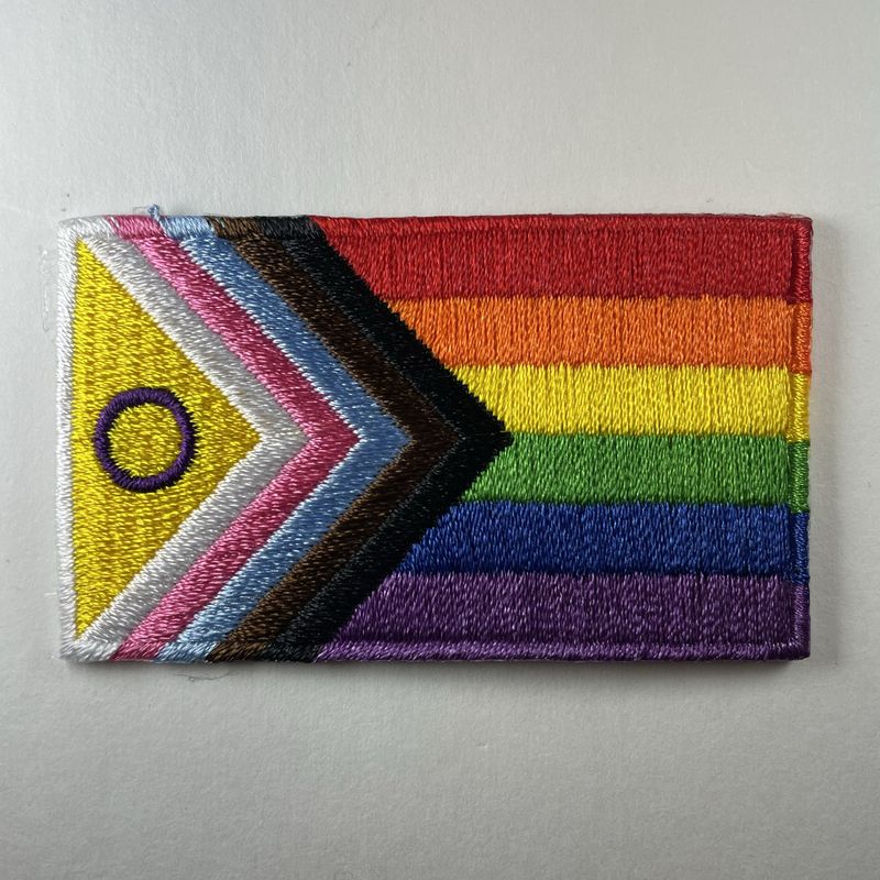 Inclusive Pride with intersex symbol badge
