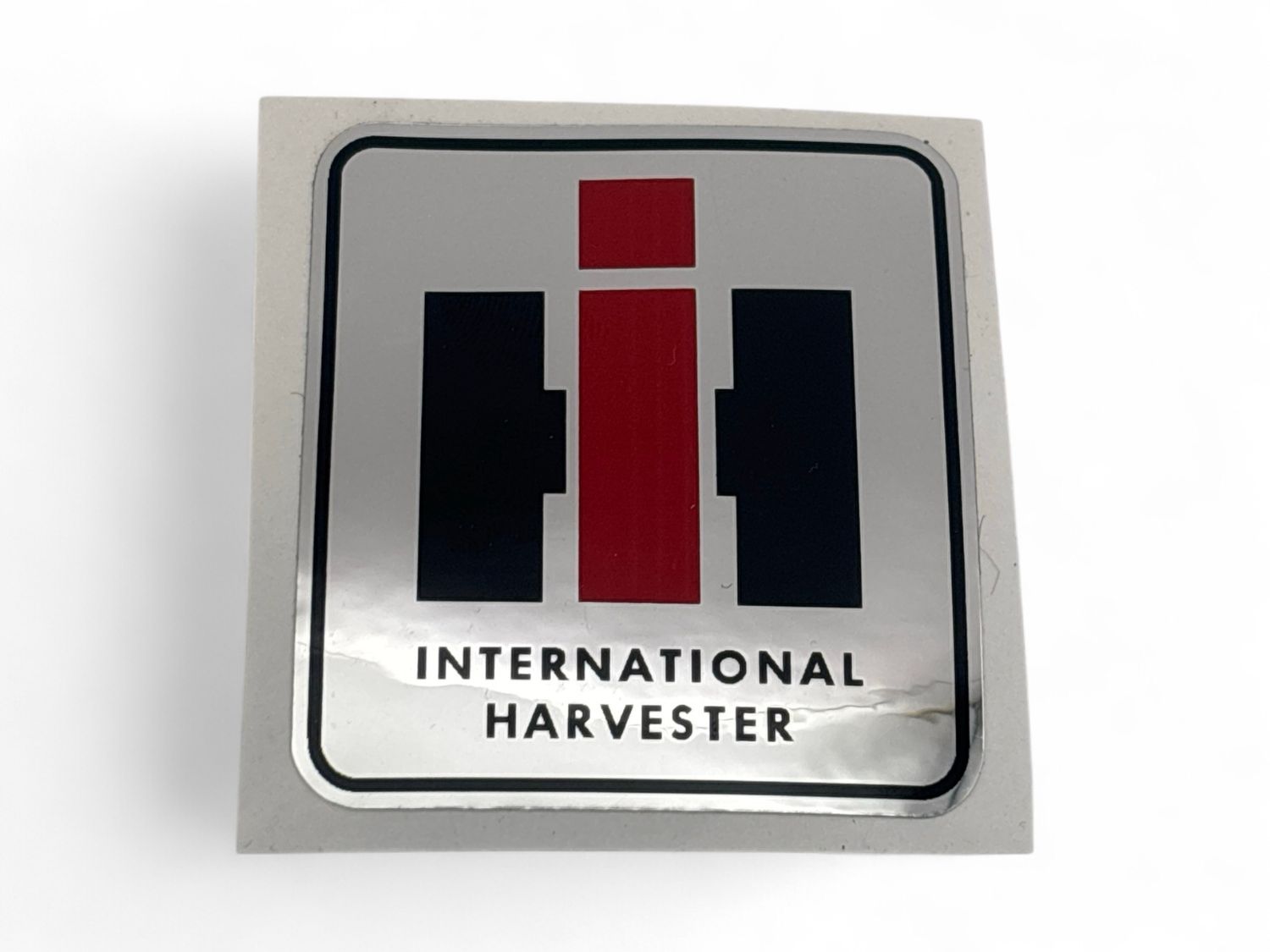 IH Logo Decal-2 '' x 2 1/4" tall With Sliver Background and Black Border