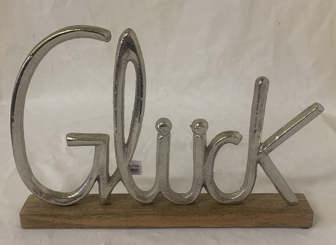 Schriftzug Glück auf Holz/Metall