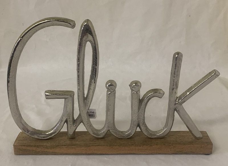 Schriftzug Glück auf Holz/Metall
