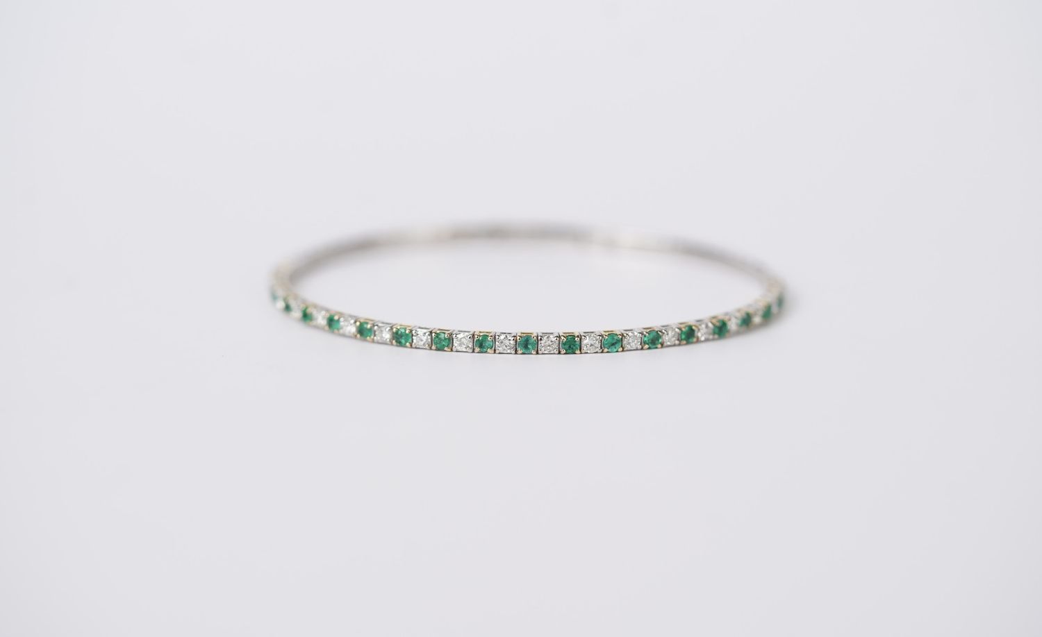 BAI- 14KWY 6.05g .72ctw Diamond .70ctw Emerald Flex Bangle