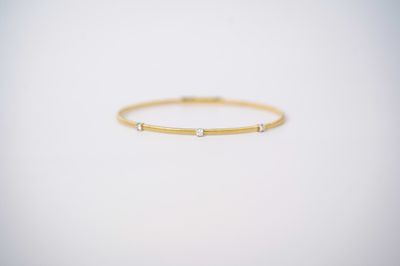 ETTX- 14KWY 4.44g .16ctw Diamond Flex Bangle