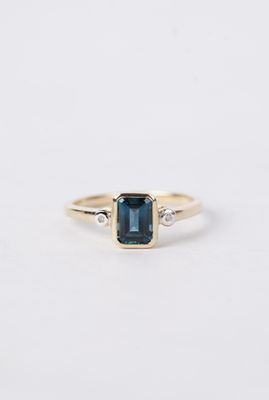 1.32 Carat London Blue Topaz and Diamond 3 Stone Bezel-Set Ring in 10k Yellow Gold 1.32 Carat London Blue Topaz and Diamond 3 Stone Bezel-Set Ring in 10k Yellow Gold