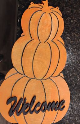 Stacked pumpkins with leaves and acorns