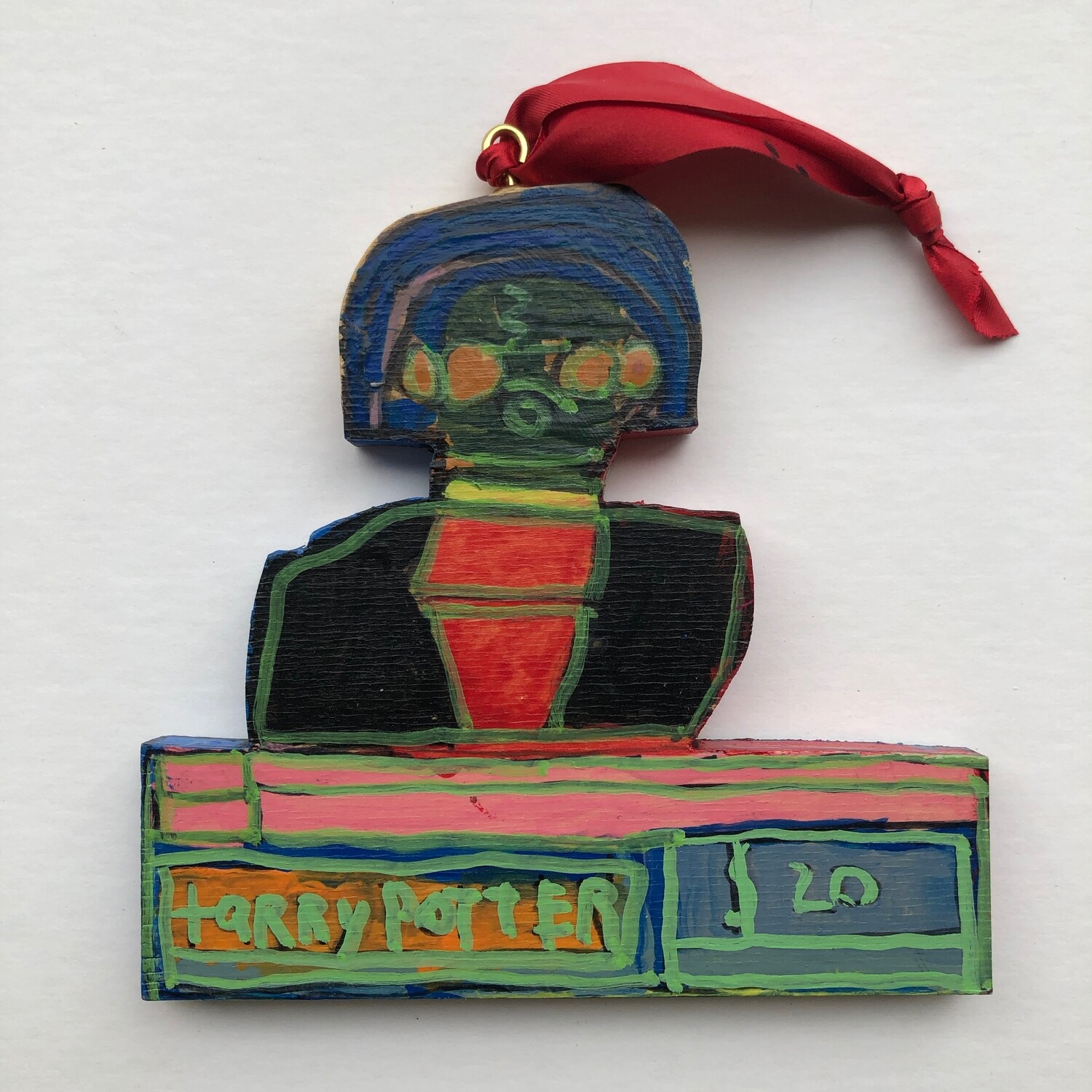 Harry Potter Christmas ornament cut out of wood with red ribbon.  Image shows Harry from chest up in house robe.
