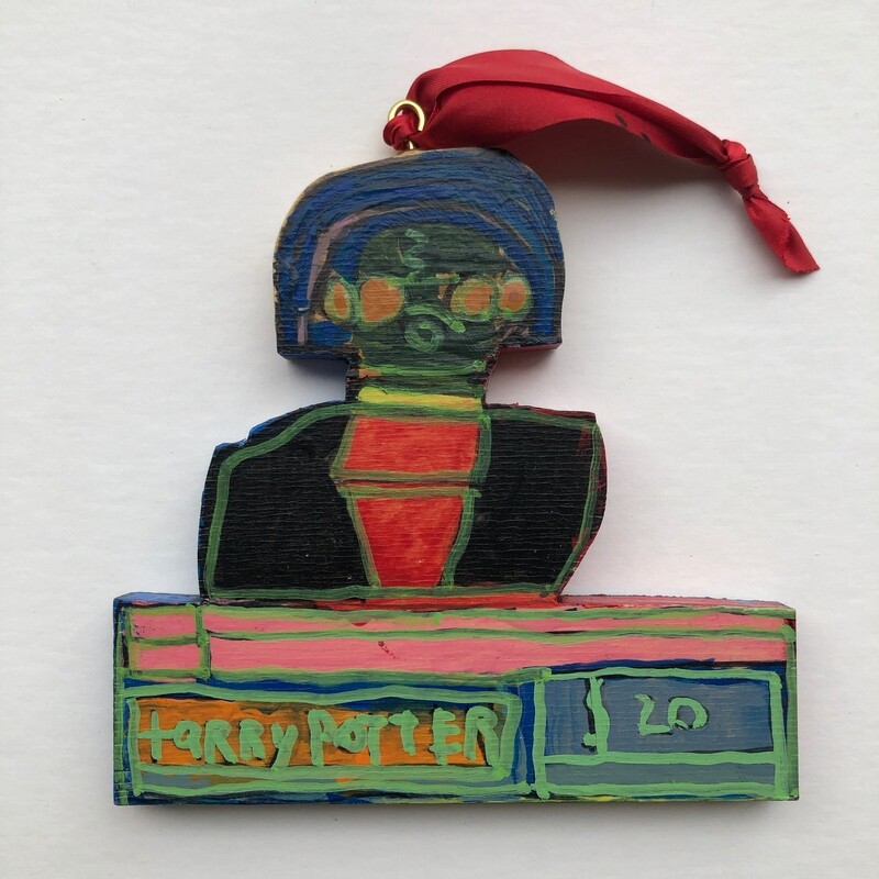 Harry Potter Christmas ornament cut out of wood with red ribbon.  Image shows Harry from chest up in house robe.
