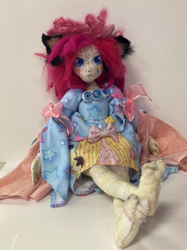 SUBMISSION Pinky Pie is a 20&quot; doll of the human version of the My Little Pony Pinky Pie. She has long curly pink felt hair with black ears peaking out. Her face has a pattern on the fabric. She has blue eyes and small lips and nose. Her dress is short with long extending sleeves. Most of the dress is blue with a star pattern on it. The center of the dress is yellow with stripes and the side is pink. Her dress has three bows on the center and sleeves. It also has three large swirls on the collar. Pinkie&#39;s legs have a pattern going down them. Her feet end with small tan hooves. 