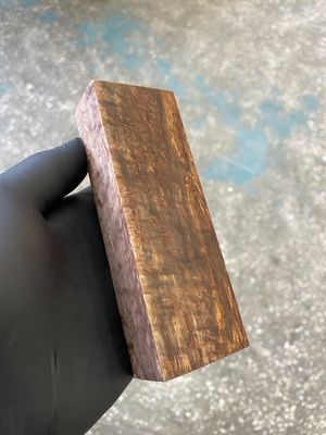 Stabilized Karelian birch wood block knife handle material close grain detail
