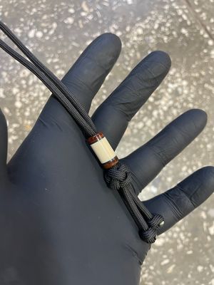 Handmade mammoth tusk lanyard bead for knife – unique prehistoric material detail