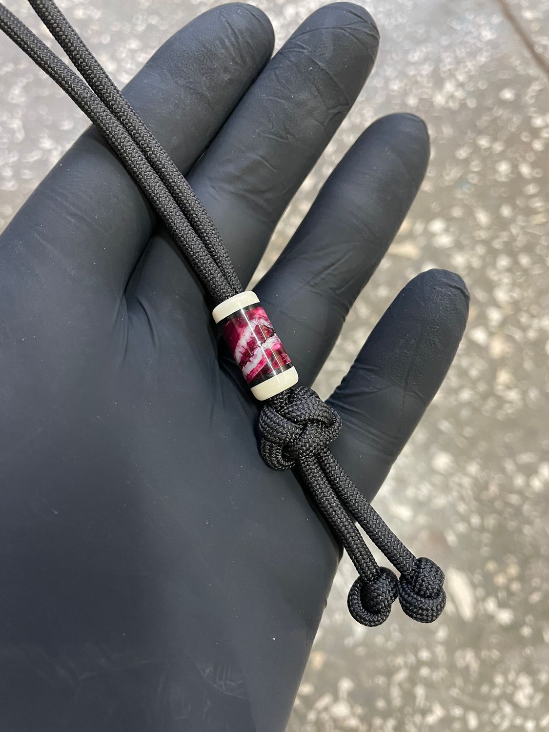 Mammoth tooth and tusk knife lanyard bead with G10 accents – stabilized fossil ivory bead close-up BE1