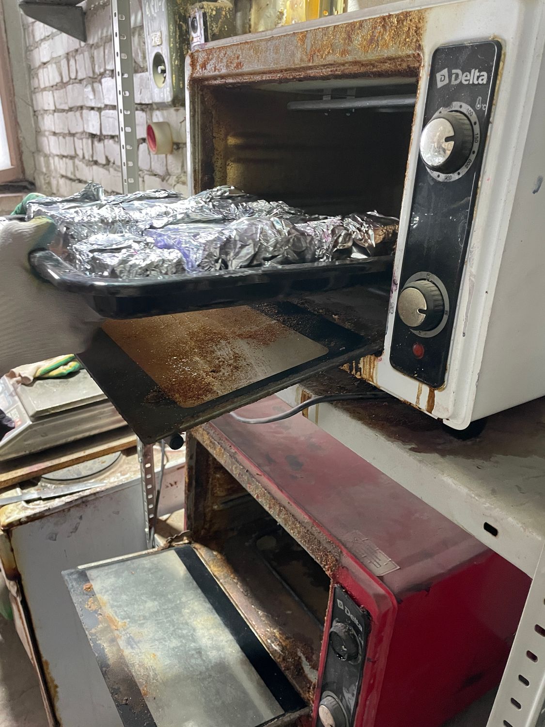 Foil-wrapped stabilized wood blocks being placed into oven for heat curing after resin impregnation