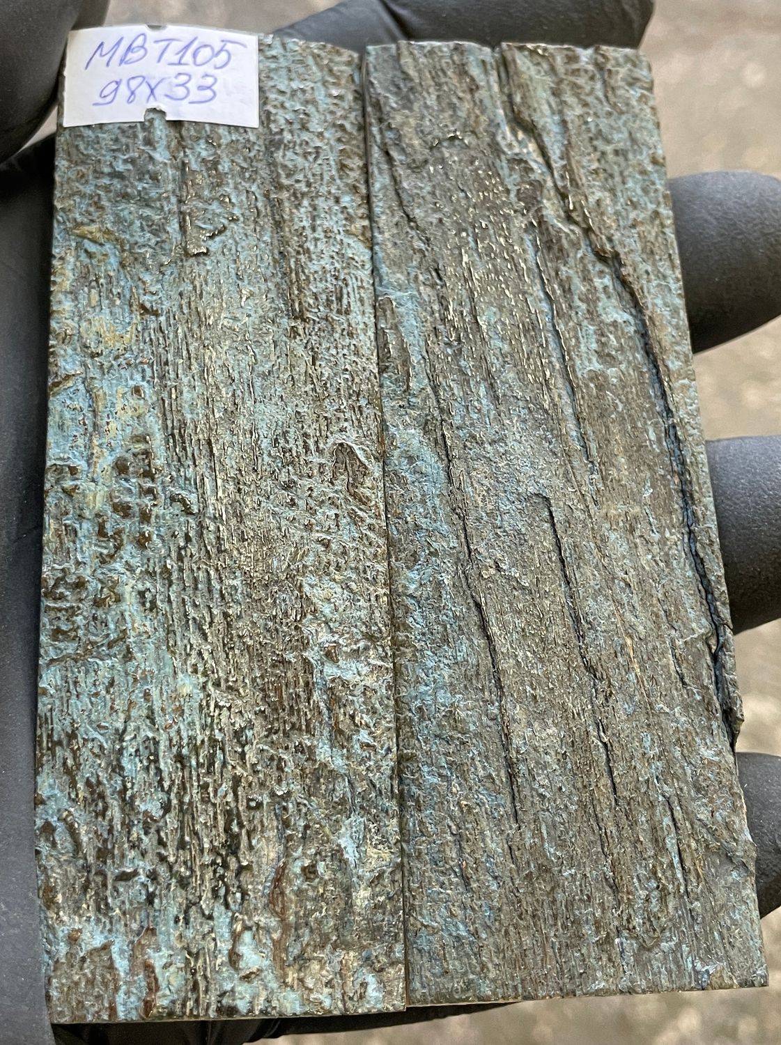 Pair of blue mammoth bark ivory knife scales with natural bluish, brown, and cream coloration.