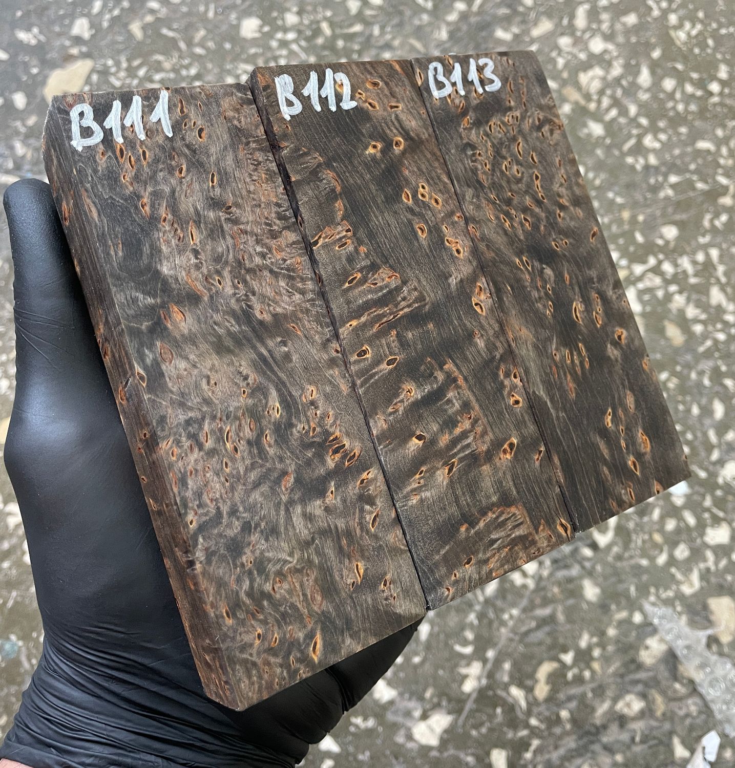 Brown-dyed stabilized Karelian birch wood blocks with distinctive figured grain