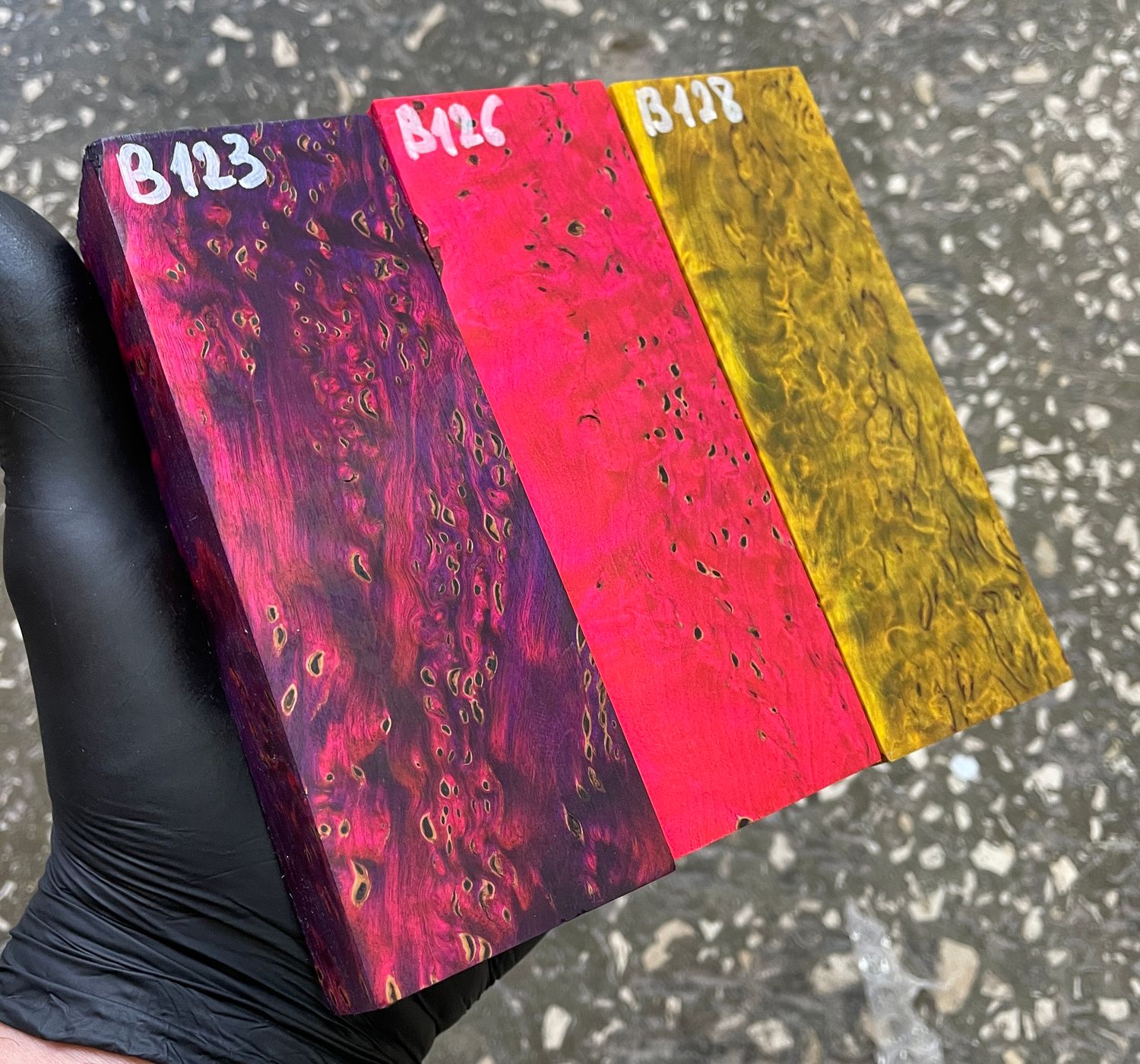 TBrightly dyed stabilized Karelian birch wood in pink, yellow, and pink-purple colors