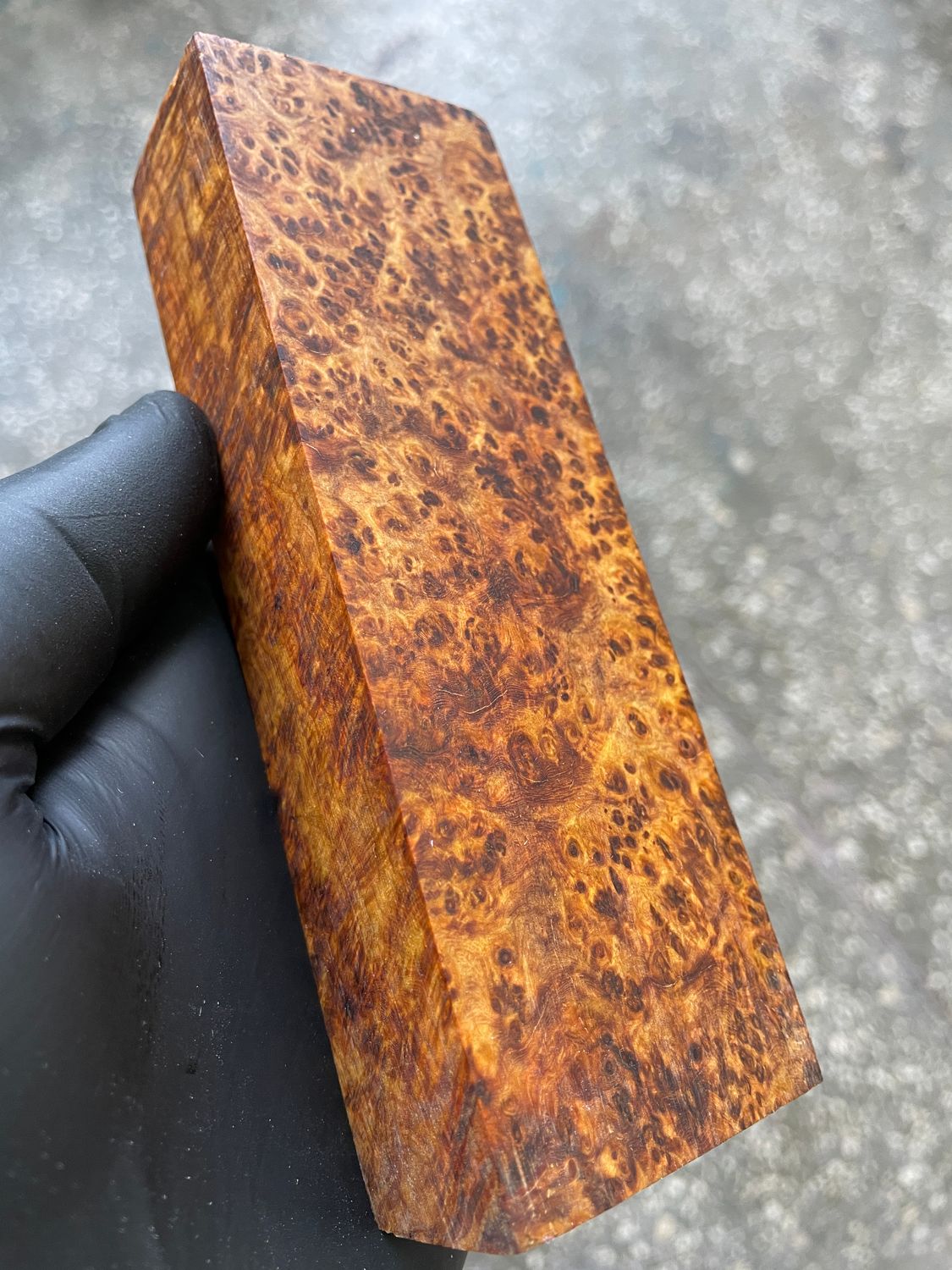 Natural Amboyna burl wood blocks featuring intricate burl eyes, swirling grain, and warm reddish-brown coloration.