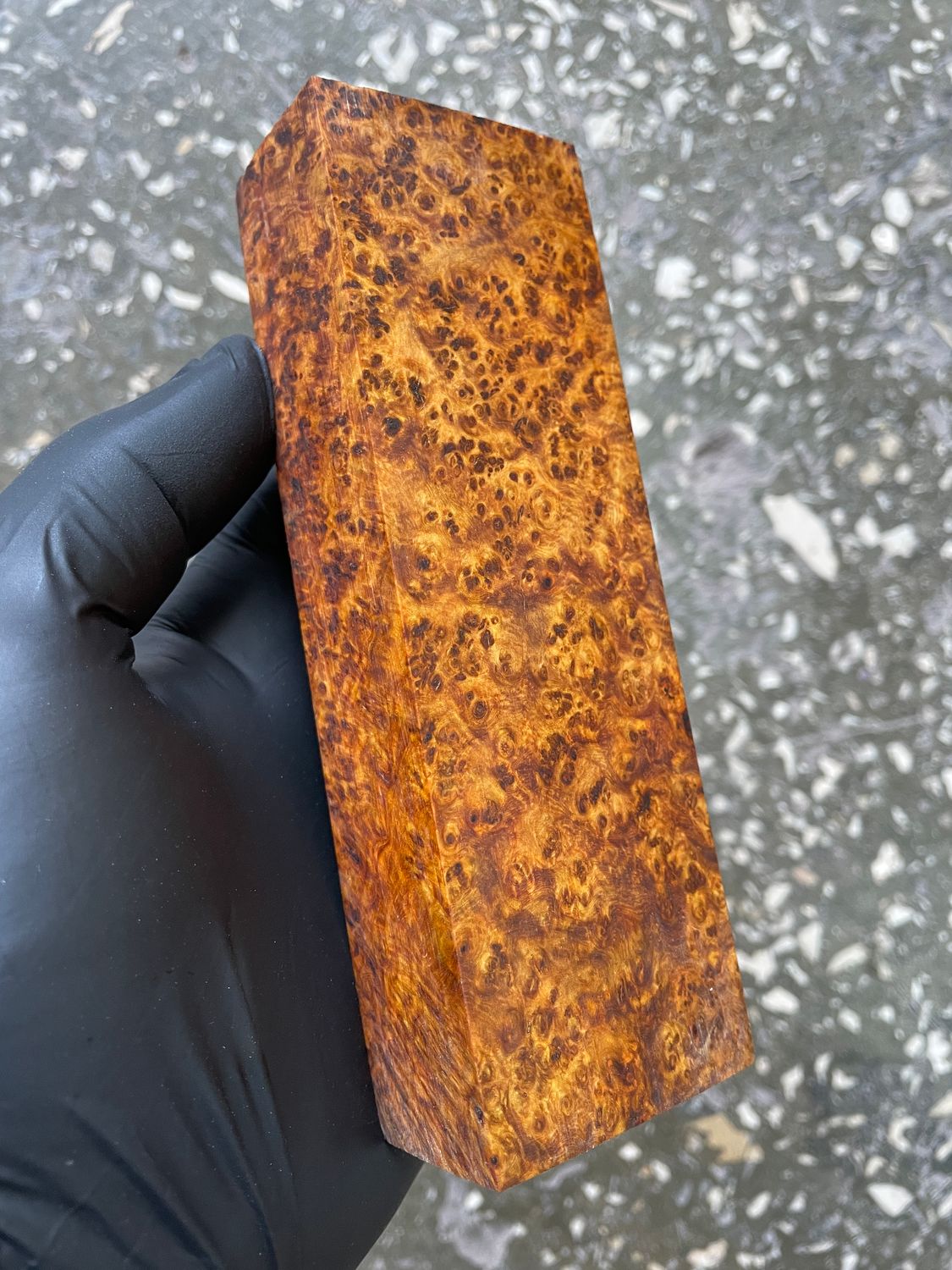 Figured Amboyna burl blocks with natural red-brown and golden tones, dense eyes, and unique grain patterns.