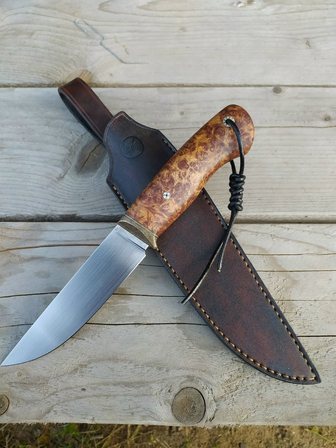 Custom knife with a highly figured Amboyna burl handle showing rich natural color and intricate burl grain.