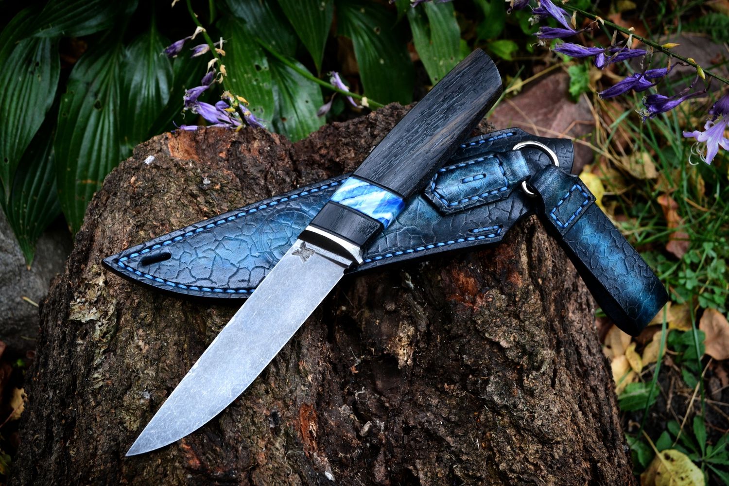 Custom handmade knife with a dark stabilized bog oak handle and distinctive natural grain.